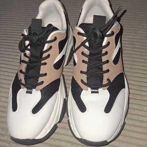 Stylish Black and White Sneakers with Tan Accents